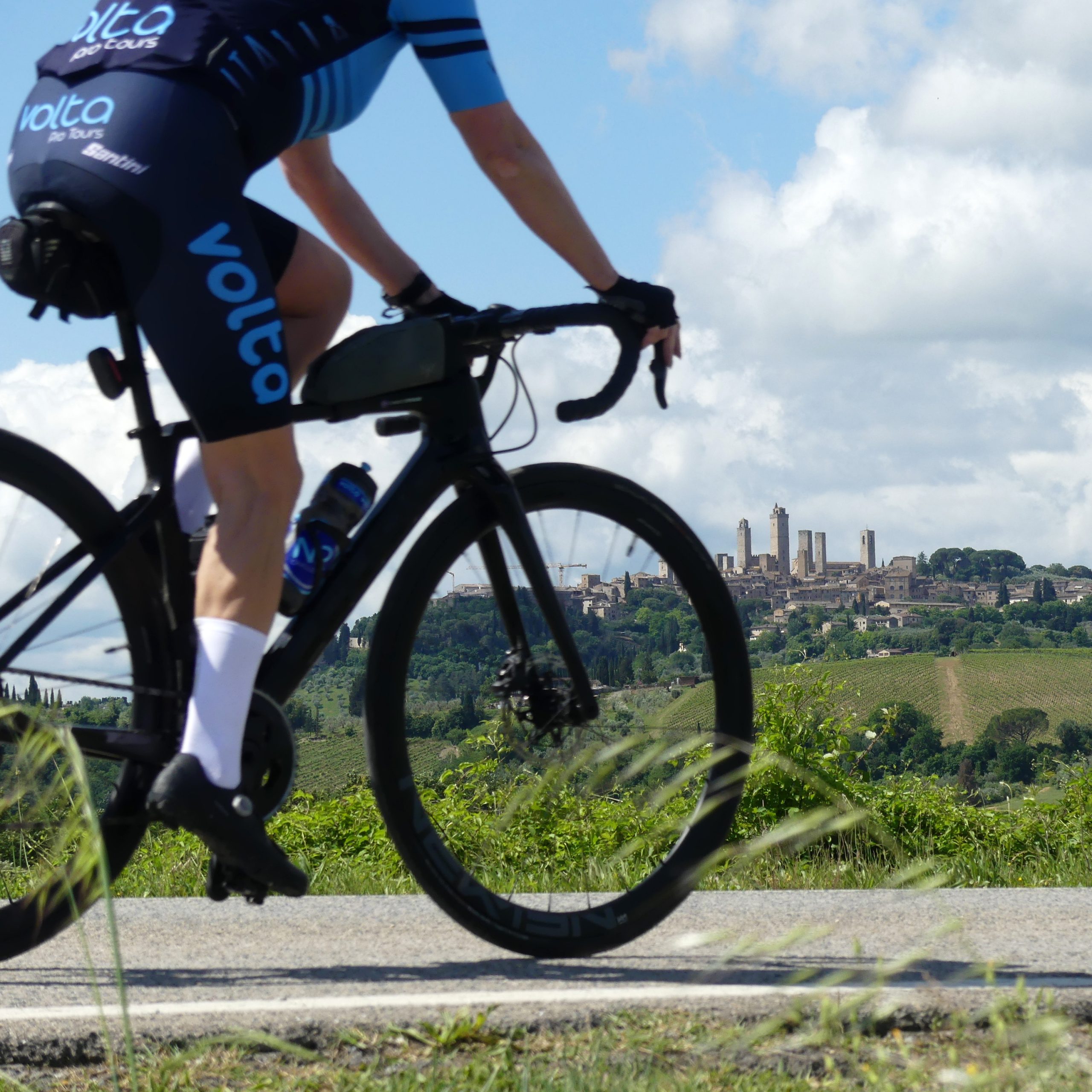 A Glimpse of San Gimignano Through the Wheel San Gimignano framed through the wheel of a cyclist